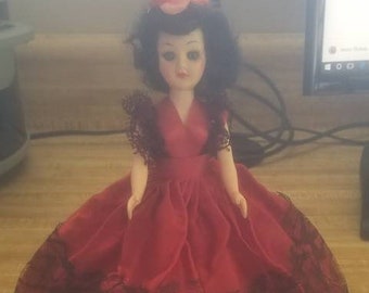 Vintage Carlson Doll with black hair and red dress