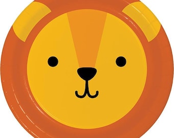 May include: A round paper plate featuring a lion's face. The plate has a yellow center with black eyes and a black nose. The outer rim and the lion's mane are orange, and the ears are yellow.