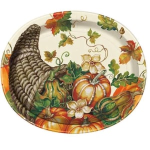 May include: Oval-shaped decorative plate with a Thanksgiving theme. The plate features a cornucopia overflowing with pumpkins, gourds, and flowers in shades of orange, green, and cream. Autumn leaves and vines are scattered around the rim.