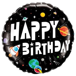 May include: A black, round foil balloon with a space theme. The balloon features the words "HAPPY BIRTHDAY" in large white letters, along with illustrations of planets, stars, a rocket ship, and a UFO.