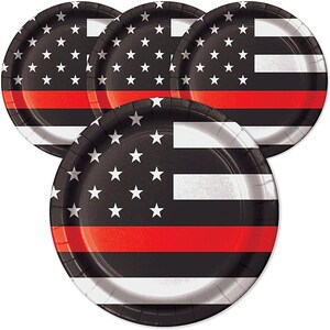 May include: A stack of five round paper plates. Each plate features a black background with white stars, a white stripe, and a red stripe. The design resembles a flag.