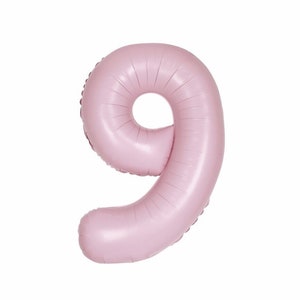 May include: A large, light pink number nine balloon. The balloon is inflated and has a metallic sheen. The number is in a sans-serif font and is suitable for a birthday or anniversary celebration.