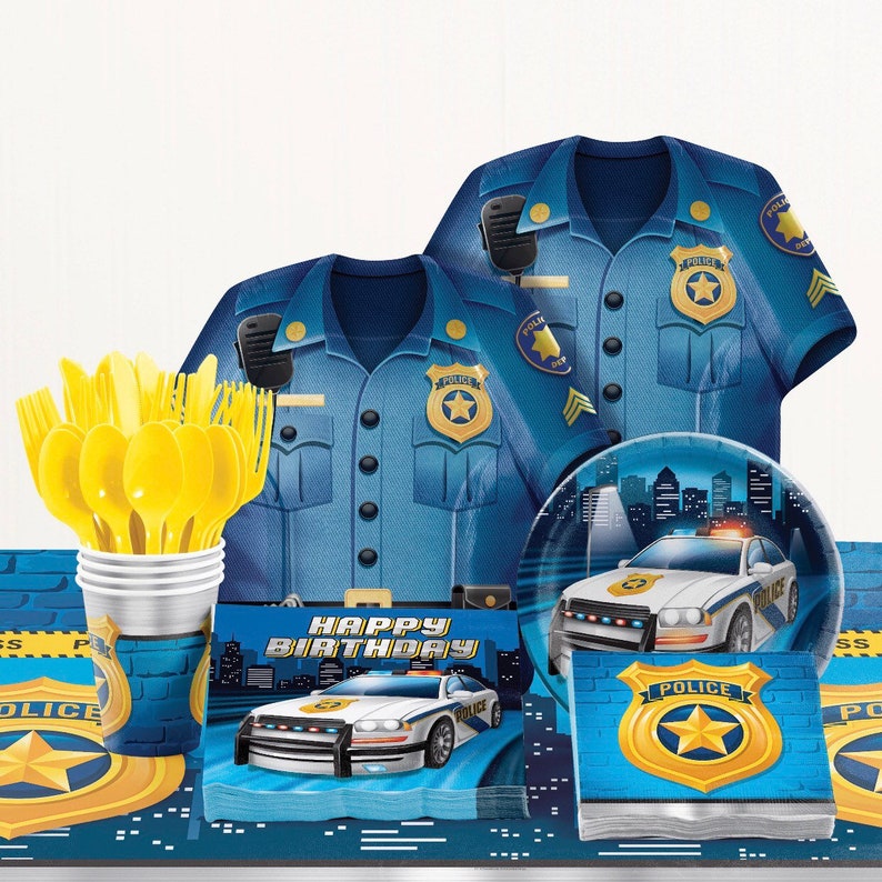 May include: A collection of police-themed party supplies. Includes blue police uniform shirts, plates, napkins, cups with yellow utensils, and a table runner. The designs feature police badges and police cars with the text "HAPPY BIRTHDAY".