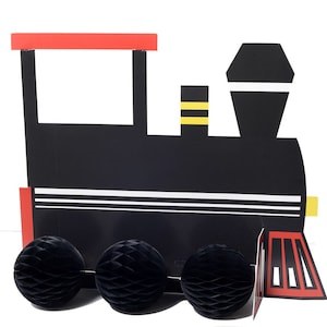 May include: A black and red cardboard train cutout with three black honeycomb wheels. The train has white stripes and yellow accents. The top of the train is red, and the wheels are round.