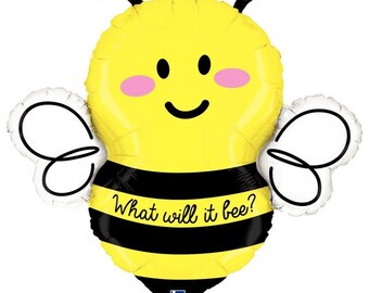 May include: A yellow bee-shaped balloon with black stripes and antennae. The balloon has a smiling face with pink cheeks and the text "What will it bee?" on the black stripe. White wings are on either side.