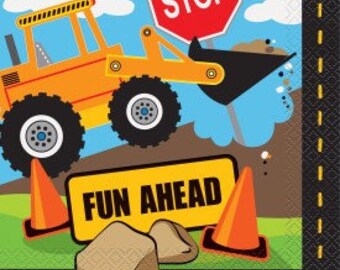 May include: A square paper napkin with a construction theme. It features an orange bulldozer, a red stop sign, and a yellow sign that reads "FUN AHEAD." Two orange traffic cones and two brown rocks are also visible.