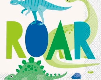 May include: A decorative napkin featuring a playful dinosaur theme. The design includes a blue dinosaur standing on a blue oval, a green stegosaurus, and a long-necked dinosaur. The word "ROAR" is spelled out in green and blue letters.