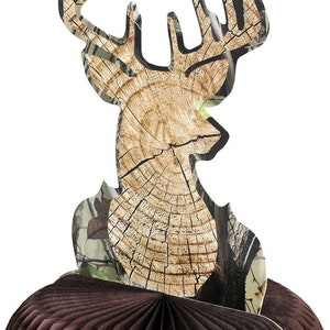 May include: A deer-shaped centerpiece with a wood-grain design and camouflage accents. The deer head is mounted on a brown honeycomb base, creating a 3D effect. Ideal for rustic or hunting-themed events.