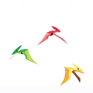 May include: Three cartoon pterodactyls flying against a white backdrop. One is red, another is green, and the third is yellow and orange. The pterodactyls have pointed beaks and wings.