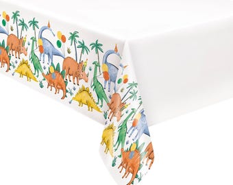 May include: White rectangular tablecloth with a colorful border featuring various dinosaurs, palm trees, and balloons. The dinosaurs are in shades of yellow, green, orange, and blue. The tablecloth is suitable for a dinosaur-themed party.