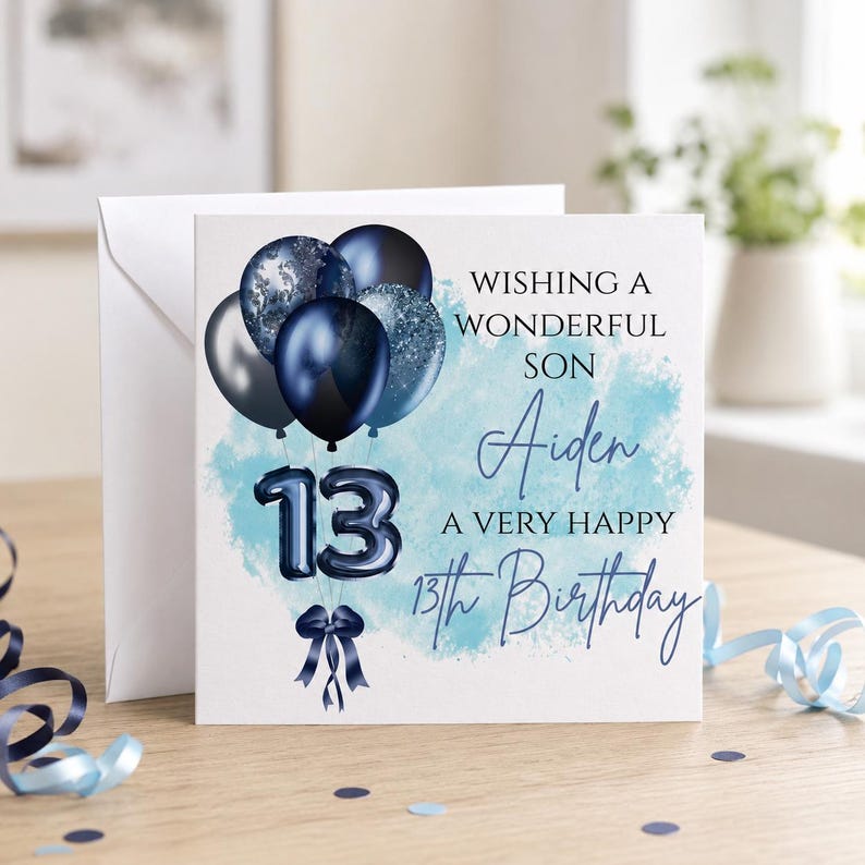 May include: A square birthday greeting card featuring a cluster of dark blue and silver balloons, the number 13 in balloon-style font, and a dark blue ribbon. The text reads: WISHING A WONDERFUL SON Aiden A VERY HAPPY 13th Birthday on a light blue background.