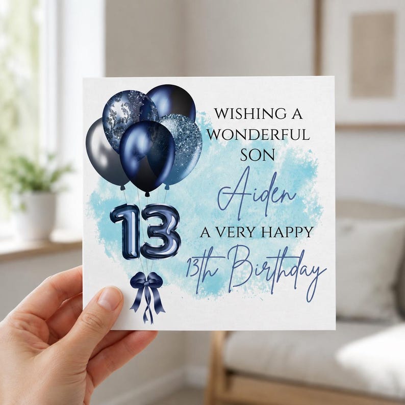 May include: A square birthday greeting card featuring a cluster of dark blue and silver balloons, a dark blue number 13 balloon, and a dark blue ribbon. The text reads: WISHING A WONDERFUL SON Aiden A VERY HAPPY 13th Birthday, set against a light blue watercolor background.