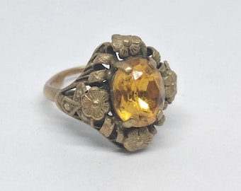 Anel floral vintage com pedra preciosa citrino, ajustável, possivelmente em latão ou cobre.