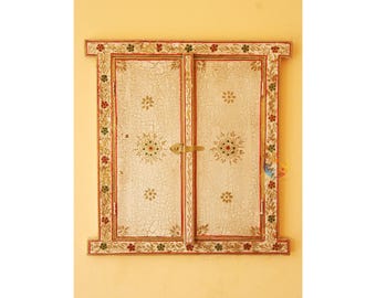 May include: A rectangular wooden wall decor piece designed like a window with two hinged doors. The surface features a distressed off-white crackle finish with hand-painted floral motifs in red, green, and gold. A brass latch secures the two doors.