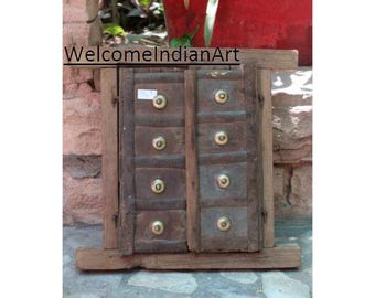 May include: A rectangular wooden wall decor piece featuring two vertical panels with a weathered brown finish. Each panel contains four square sections, each adorned with a centered, polished brass knob. The text WelcomeIndianArt is visible.