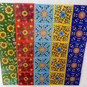 May include: A set of 24 ceramic tiles featuring floral patterns in shades of green, red, blue, and yellow. The tiles are arranged in four rows of six tiles each.