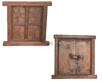 May include: Two rectangular wooden window frames with brown tones. The left frame features four carved panels depicting figures in motion. The right frame consists of two solid wooden shutters secured by a central metal latch and iron hinges.