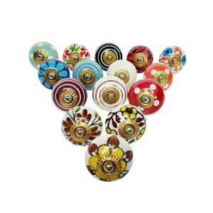 May include: Assortment of 15 ceramic drawer knobs with various floral and geometric patterns in shades of blue, red, green, yellow, and white. Each knob features a gold metal accent.