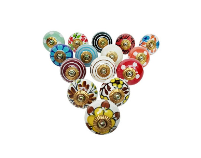 May include: Assortment of 15 ceramic drawer knobs with various floral and geometric patterns in shades of blue, red, green, yellow, and white. Each knob features a gold metal accent.