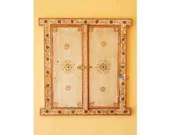 May include: A rectangular wooden wall decor piece designed like a window with two hinged doors. The surface features a distressed off-white crackle finish with hand-painted floral motifs in red, green, and gold. A brass latch secures the two doors.