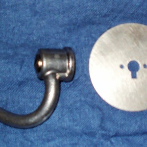 May include: A silver metal dough hook, a silver metal disc with a hole in the center, and a silver metal attachment with a small hole in the center.