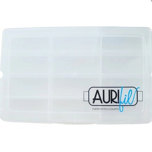 May include: A clear plastic storage box with multiple compartments. The box has a rectangular shape and a hinged lid. The logo "AURIfil" in black and blue is printed on the lower right corner, with the text "EVERY STITCH COUNTS" below it.