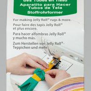 May include: Fabric Tube Maker package with the Clover logo. The package includes text in multiple languages, including English, French, and Spanish. The image shows a sewing machine and hands using the tube maker to create fabric tubes.