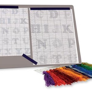 May include: A cross-stitch kit with a gray background and two white sheets with a grid pattern and the alphabet printed on them. The kit includes a variety of colored embroidery floss.