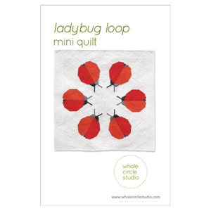 May include: A quilt pattern featuring a ladybug loop design. The quilt is white with red and gray ladybugs. The text "ladybug loop mini quilt" is at the top of the image. The text "whole circle studio" is at the bottom of the image.