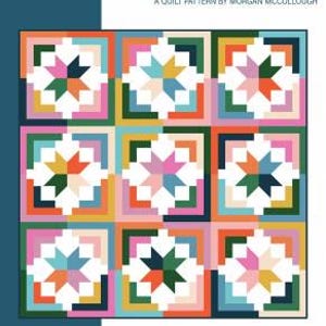 May include: A quilt pattern named "cozy cabin" by Morgan McCollough. The design showcases a grid of colourful star-shaped blocks in shades of pink, green, orange, and blue. The words "baby, throw, bed" are also visible.