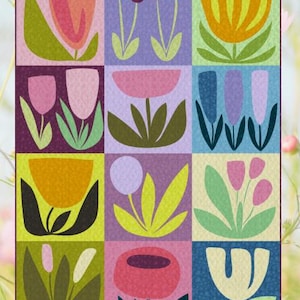 May include: A colourful floral quilt with a grid pattern. Each square features a different stylised flower in shades of pink, orange, yellow, and blue, set against various pastel backgrounds. The quilt has a textured appearance.