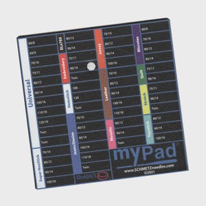 May include: A black and white sewing needle guide with various needle sizes and types. The guide includes the text "myPad" and "SCHMETZneedles.com". It features color-coded sections for different fabrics and needle types, such as Universal, Embroidery, and Jeans/Denim.