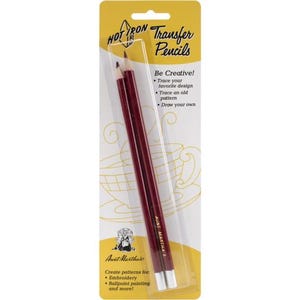 May include: A package of Aunt Martha's Hot Iron Transfer Pencils. The package is yellow and clear, with two maroon pencils visible. Text on the package includes "Be Creative!" and instructions for use. The pencils are for embroidery and ballpoint painting.