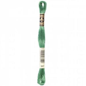 May include: A skein of DMC embroidery floss in color 367, a medium green shade. The floss is wound on a white cardboard spool with a gold and black label that reads "DMC 25" and has a barcode.