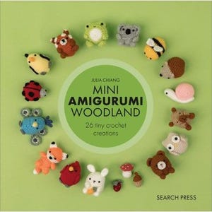 May include: A book cover on a green background displays a circular array of 26 miniature crochet woodland creatures. The book title, "Mini Amigurumi Woodland," is within a green circle. The author is Julia Chiang, and the publisher is Search Press.
