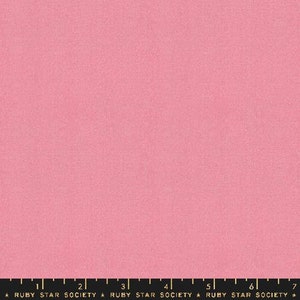 May include: Plain pink fabric with a slightly textured surface. A black ruler with white markings and the text "RUBY STAR SOCIETY" is at the bottom of the image.