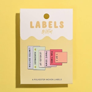 May include: A rectangular product package labeled LABELS BY KATM containing 6 polyester woven labels. The package displays six colorful fabric tags with the text: LIMITED EDITION, HANDMADE, LEVELED UP, PANIC SEWN, FUN TIMES, and 1 OF 1.