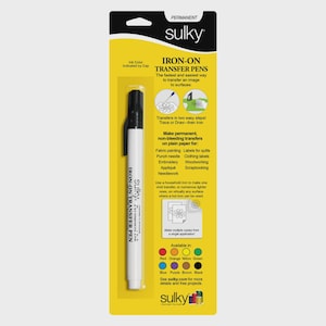 May include: A white Sulky Iron-On Transfer Pen with a black cap, displayed on a yellow and black product package. The package includes text about the pen's uses for fabric painting, embroidery, and other crafts. The pen is designed for transferring images to surfaces.