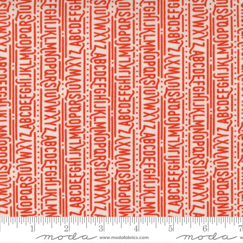 May include: White fabric with a repeating pattern of red letters of the alphabet. The letters are arranged in vertical columns and are slightly offset from each other. The fabric is measured with a ruler in inches.