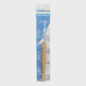 May include: A stiletto and pressing tool in a clear plastic package. The tool has a wooden handle and a metal tip. The packaging includes the text "byannie.com" and "Stiletto & Pressing Tool". The tool is designed for precision placement and holding.