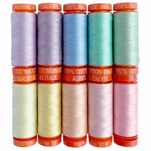 May include: Six spools of pastel colored thread, each with a label that reads "100% Cotton" and "Aurifil Made in Italy".
