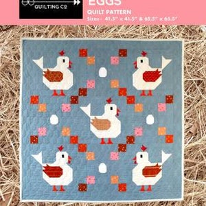 May include: A quilt pattern featuring a blue background with white chickens and eggs. The pattern is called "Scrambled Eggs" and is a confident beginner level project. The pattern is available in two sizes: 41.5" x 41.5" and 65.5" x 65.5".
