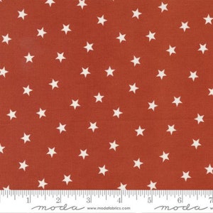 May include: Red fabric with a white star pattern. The fabric is a solid red color with white stars scattered across the surface. The stars are evenly spaced and are a simple, five-pointed design.