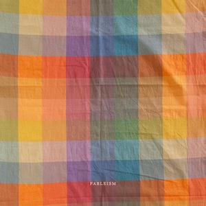 May include: A colorful plaid fabric with a variety of colors including orange, yellow, green, blue, and purple. The word "FABLEISM" is printed in white at the bottom right corner of the fabric.