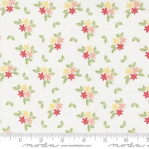 May include: White fabric with a repeating pattern of small bouquets of pink, yellow, and red flowers with green leaves.