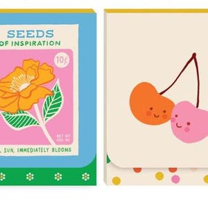 May include: Two small notebooks with a retro design. The first notebook has a blue cover with a pink and orange flower illustration and the text "Seeds of Inspiration 10c". The second notebook has a cream cover with a pink and orange cherry illustration.
