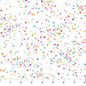 May include: White fabric with a colorful confetti pattern. The confetti includes stars, dots, triangles, and other shapes in shades of orange, yellow, pink, purple, and blue. A ruler is printed along the bottom edge, marked in inches.
