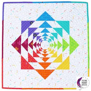 May include: A square, rainbow-colored quilt with a geometric pineapple design. The quilt features a white background with colorful triangles and a central pineapple pattern in shades of blue, purple, pink, red, orange, yellow, and green.