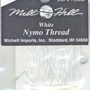 May include: A spool of white Mill Hill Nymo thread made of 100% nylon, containing 9 yards. The black packaging features the text 40218, Mill Hill, White Nymo Thread, and Wichelt Imports, Inc. Stoddard, WI 54658, with a circular hanging hole at the top.