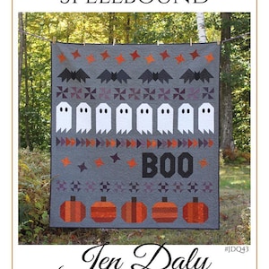 May include: A Halloween quilt with a grey background, featuring bats, ghosts, pumpkins, and the word "BOO." The quilt is adorned with stars and geometric patterns. The text "SPELLBOUND" is at the top.